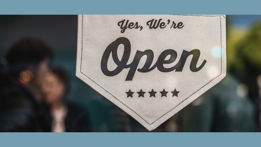 Small business showing Open sign on their window. The photo is symbolic for a small business owner struggling to be an expert in everything